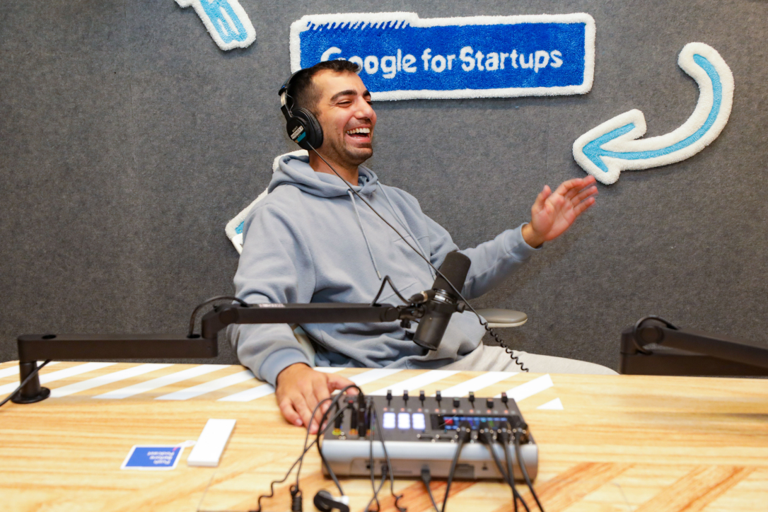 Radio host laughing with mic while recording in radio studio