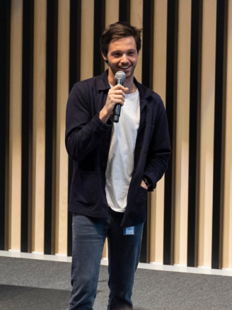 A man is giving a speech on stage.