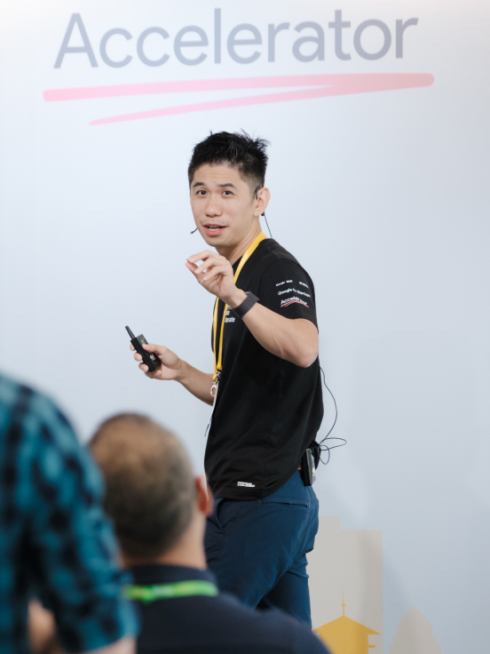 A boy is answering question of one of the boy from audience while presenting