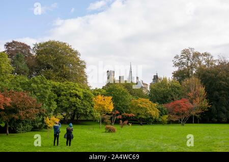 Cardiff, Wales, UK, October 16th 2019. People photograph Cardiff Castle and autumnal trees in Cooper's Field on an unusually sunny day after a spell of consistent rain. Credit: Mark Hawkins/Alamy Live News Stock Photo