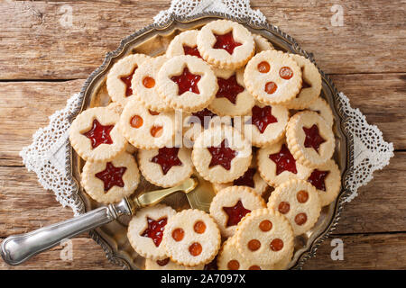 Linzer cookies with jam on a plate on the table. Traditional Austrian biscuits filled. Horizontal top view from above Stock Photo