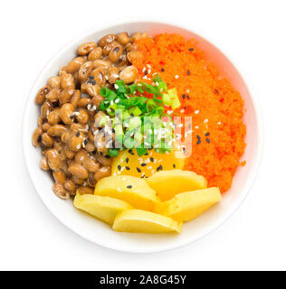 Rice don with natto, tobiko egg and pickled radish in soy sauce japan food fusion style on top spring onion and sesame top view Stock Photo