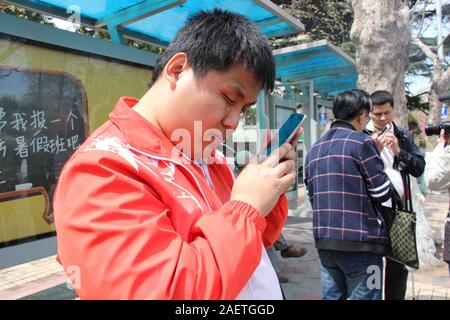 Local blind people take bus via the help of Daodao bus, a mobile app that enable bus to 'speak' via loudspeaker and Internet to notice blind people, i Stock Photo