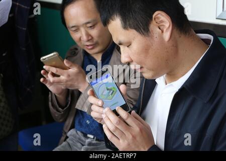 Local blind people take bus via the help of Daodao bus, a mobile app that enable bus to 'speak' via loudspeaker and Internet to notice blind people, i Stock Photo