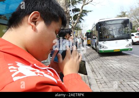 Local blind people take bus via the help of Daodao bus, a mobile app that enable bus to 'speak' via loudspeaker and Internet to notice blind people, i Stock Photo