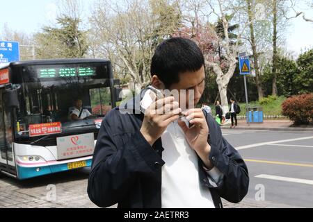 Local blind people take bus via the help of Daodao bus, a mobile app that enable bus to 'speak' via loudspeaker and Internet to notice blind people, i Stock Photo