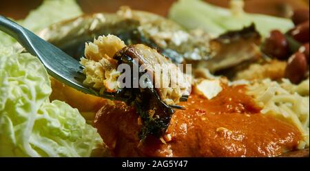 Kenkey with fried fish and chili pepper, Ghanaian cuisine, Traditional assorted African dishes, Top view. Stock Photo