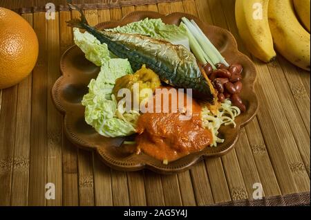 Kenkey with fried fish and chili pepper, Ghanaian cuisine, Traditional assorted African dishes, Top view. Stock Photo