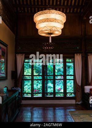 interior of traditional home looking out to garden through patio doors, Ho Tay suburb, West Lake, Hanoi, Vietnam, Asia Stock Photo