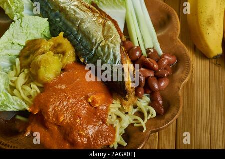 Kenkey with fried fish and chili pepper, Ghanaian cuisine, Traditional assorted African dishes, Top view. Stock Photo