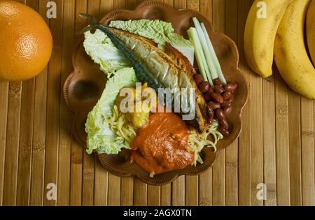 Kenkey with fried fish and chili pepper, Ghanaian cuisine, Traditional assorted African dishes, Top view. Stock Photo