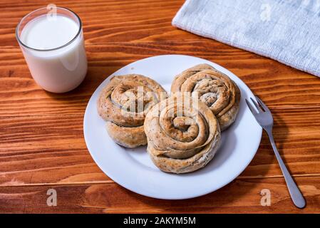 Domestic Home made Rolled pastry with spinach and cheese on a napkin with a glass of Yogurt Stock Photo