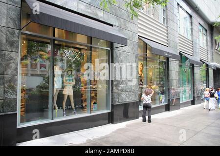 CHICAGO, USA - JUNE 26, 2013: Shopper walks by Forever 21 fashion store at Magnificent Mile in Chicago. The Magnificent Mile is one of most prestigiou Stock Photo