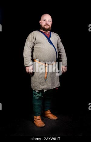 Overweight bearded man in the image of a medieval merchant Stock Photo