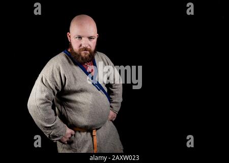 Overweight bearded man in the image of a medieval merchant Stock Photo