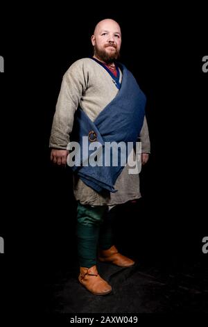 Overweight bearded man in the image of a medieval merchant Stock Photo