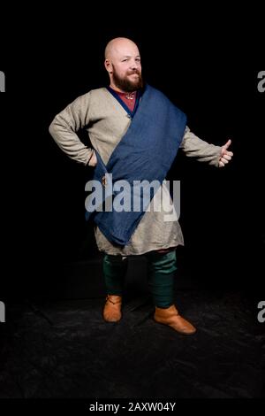 Overweight bearded man in the image of a medieval merchant Stock Photo