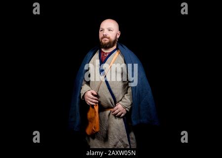 Overweight bearded man in the image of a medieval merchant Stock Photo