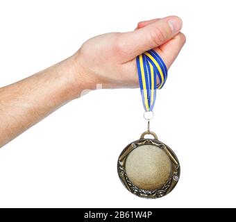 Gold Medal winner in the hand. On a white background. Stock Photo