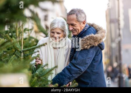 Elderly Couple Having Fun Outdoors At Christmas Time Stock Photo