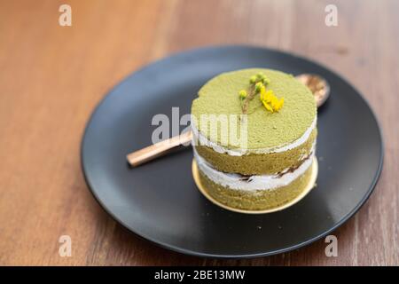 Close up. Matcha green tea cup cake, home made style, dessert cake in bakery. Stock Photo