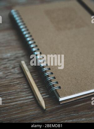 An old fashioned desk top with a ring binder note book and pencil for taking notes and creative writing with copy space Stock Photo