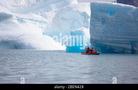 2 men traveling with a sea kayak in Eastern Greenland Stock Photo