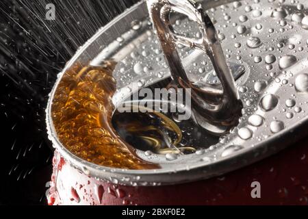 Spray from a fizzy drink on opening a ring pull can. Stock Photo