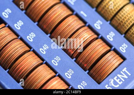 Open cash registrer containing many coins of euros in raw Stock Photo