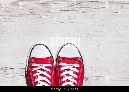 Old red shoes on wooden background Stock Photo