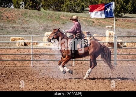 Cowboy with gun on horse, mounted shooting competition, End of Trail Wild West Jubilee, near Albuquerque, New Mexico USA Stock Photo