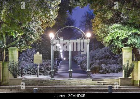 ATHENS, GEORGIA - JANUARY 17, 2018:  The  University of Georgia campus arch with historic state marker in wintertime at twilightl. Stock Photo