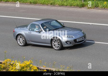 2009 silver Mazda Mx-5 I Roadster SPT Tech sportscar; Vehicular traffic moving vehicles, cars driving vehicle on UK roads, motors, motoring on the M6 motorway highway network. Stock Photo