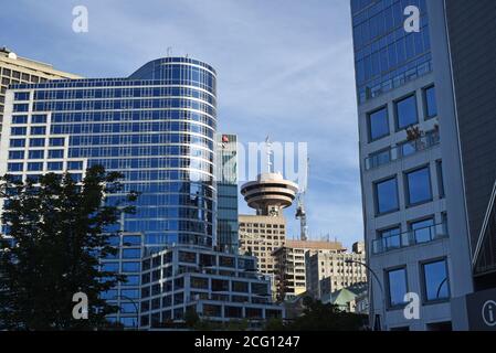 A view through downtown buildings to the Harbour Centre building topped with a revolving restaurant  in Vancouver, British Columbia, Canada. Stock Photo