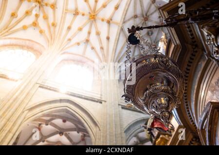 close up of a thurible, a silver censer use to spread incense during masses inside an ancient catholic church with natural light, also known as turibu Stock Photo