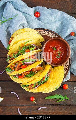 Mexican tacos with corn tortilla and meat on wooden background. Top view Stock Photo