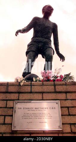 Flowers, cards and football scarves are laid in tribute to Sir Stanley Matthews, at a statue of the star at the Potteries shopping centre in Hanley, Stoke-on-Trent.  The former Blackpool and Stoke City winger died aged 85,  after a short illness. Stock Photo