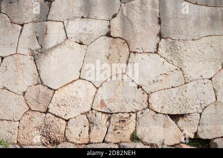 Cyclopean wall of oracle Delphi - Greece - characterized by the use of massive stones of irregular shape and size of passage Stock Photo