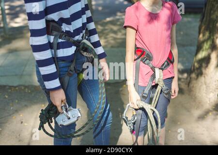 Children prepare for a bungee jump, put on safety belts Stock Photo