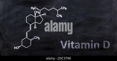 Vitamin D D3 structural chemical formula, drawing on a chalk black board, School chemistry class. Cholecalciferol, colecalciferol, C27H44O molecule. Stock Photo