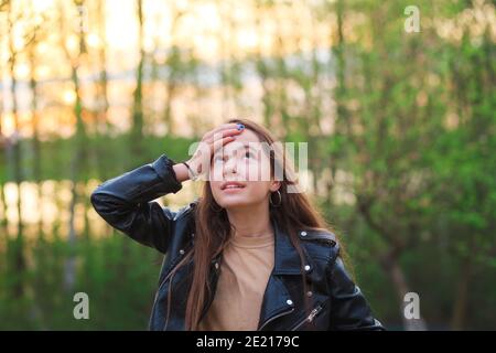 Beautiful Teen Girl is smiling and  enjoying nature in the park at Spring sunset Stock Photo