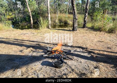 A campoven, or cooking pot, is prepared next to a campfire in the Outback at Lorella Springs Wilderness Park, near Borroloola, Northern Territory, NT, Stock Photo