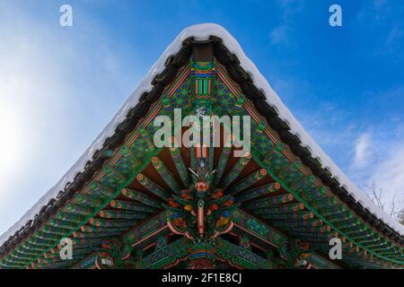 Snow-covered roof of Baekyangsa temple, beautiful Buddhist traditional architecture landscape. Baekyangsa Temple in Jeollanam-do, South Korea. Stock Photo