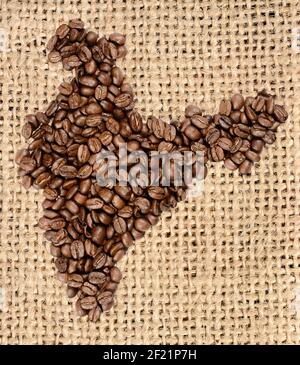 Whole bean coffee. The contour of the India is made from coffee beans on jute burlap Stock Photo