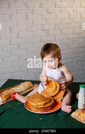 Little chef. Little kid dressed as a chef with pastries, buns, bread Stock Photo