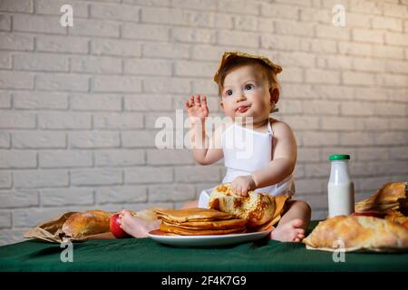 Little chef. Little kid dressed as a chef with pastries, buns, bread Stock Photo