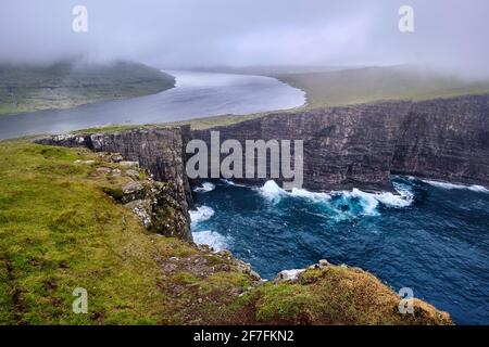 Cliffs of Traelanipa with the lake above the ocean, Faroe Islands, Denmark, Europe Stock Photo