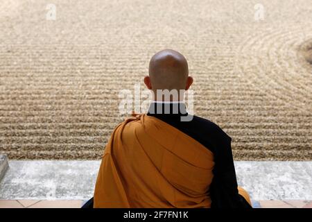 Zen Buddhist master practising Zazen (meditation) in Orval Trappist Abbey's Zen garden, Belgium, Europe Stock Photo