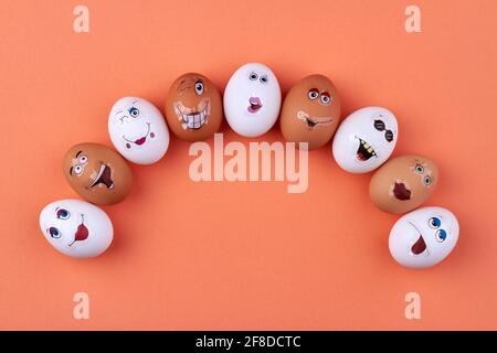 Group of white and brown eggs with smiley faces. Stock Photo