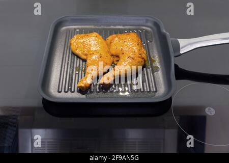 Two chicken legs in a frying pan Stock Photo